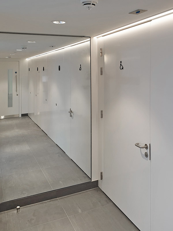 Manufacture and supply of bespoke FSC® certified “Pure White” RAL 9010 factory spray paint lacquered flush rebated washroom cubicle fronts.